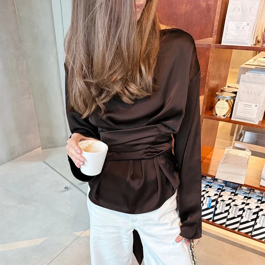 Dark brown high-neck blouse with long sleeves and gathered waist tie detail