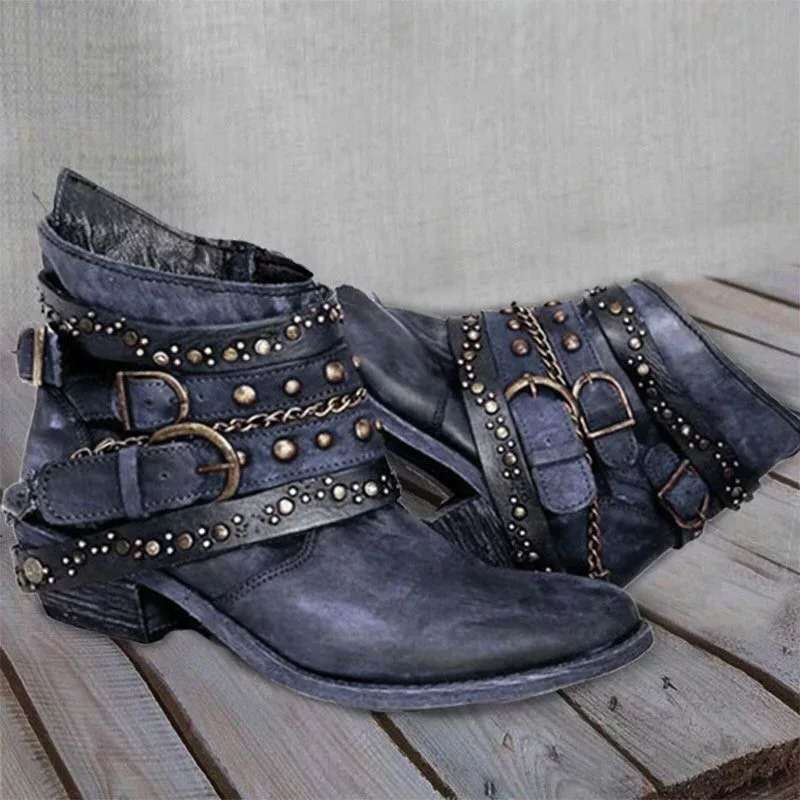 Blue vintage ankle boots with studded trim, buckle straps, and chain detail