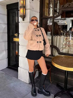 Beige sherpa-style button jacket with toggle hardware, long sleeves