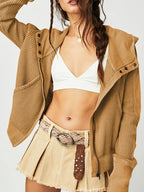 Brown waffle hoodie with hood and zip front, worn over a white bralette