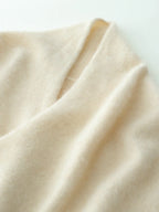 Beige knit sweater sleeve cuff and collar area with soft drape and seam line