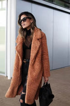 Soft long teddy fleece coat in rust apricot brown, open front with fuzzy lapels.