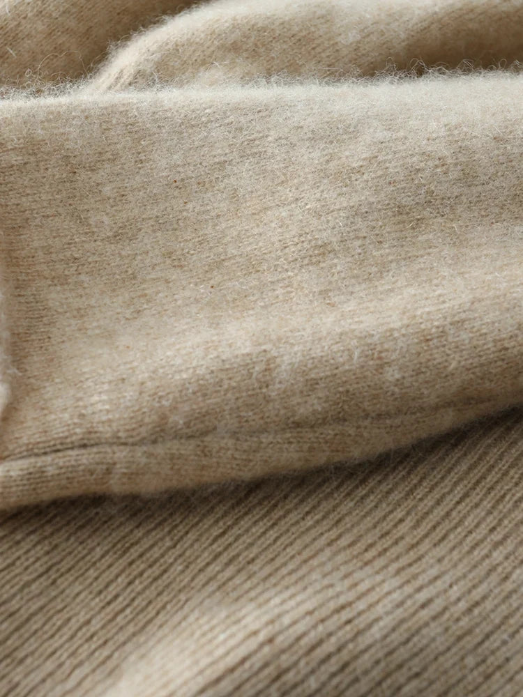 Close-up of beige knit sweater sleeve cuff and ribbed texture detail