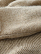 Close-up of beige knit sweater sleeve cuff and ribbed texture detail
