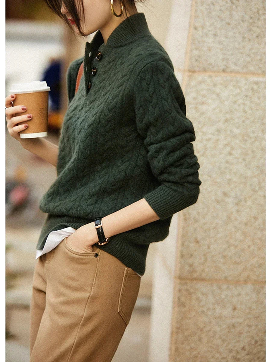 Dark green cable-knit cashmere button-up sweater with button-front placket and ribbed hem.