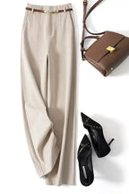White high-waisted wide-leg trousers with a smooth waistband and side drape