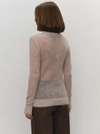 Back view of lightweight crewneck knit sweater in light beige with ribbed hem and cuffs