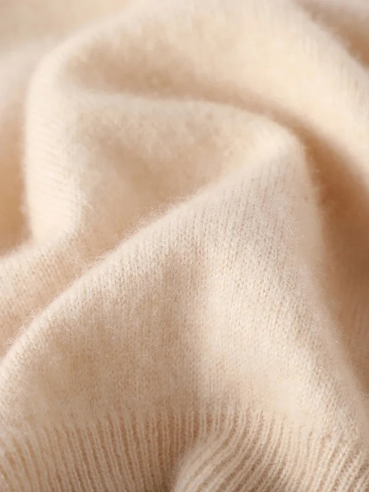 Close-up knit texture of a beige half-zip mock neck sweater fabric