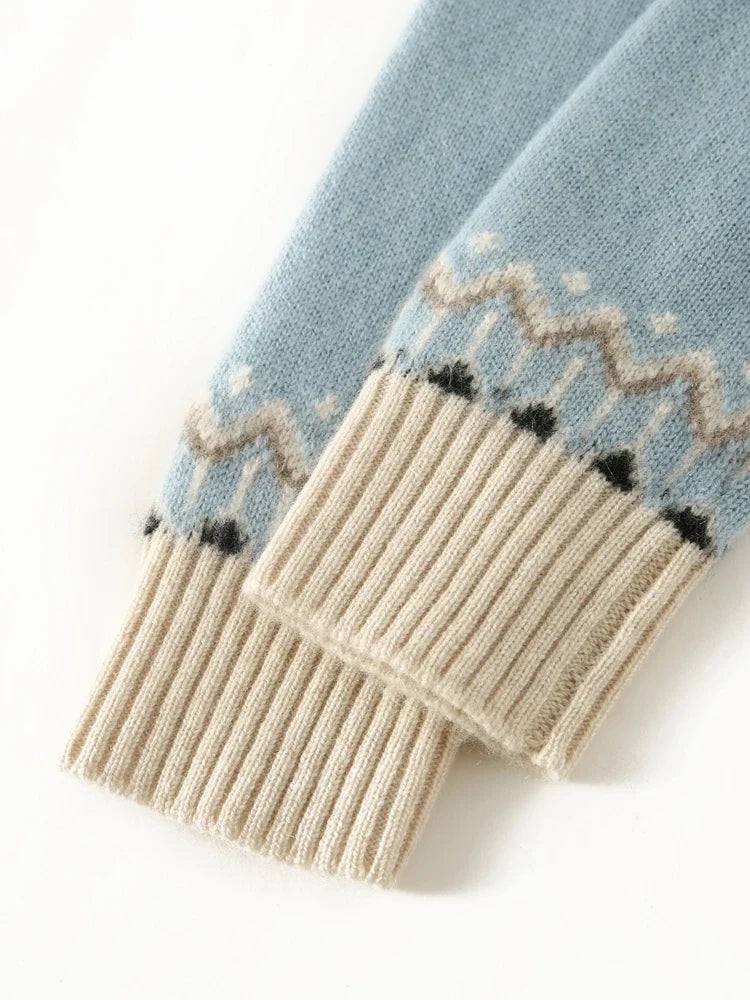 Ribbed cuff detail on sky blue Fair Isle sweater with cream motif band