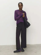 Purple crewneck knit sweater with long sleeves and ribbed cuffs