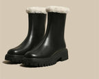 Black ankle boots with plush fleece cuffs and chunky treaded sole