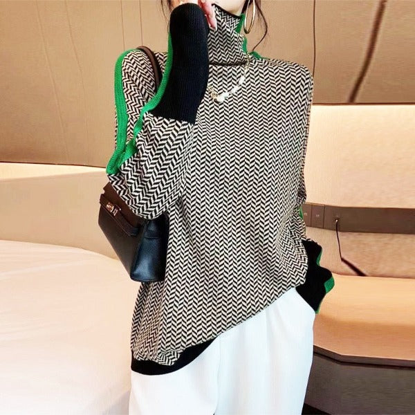 Black-and-white herringbone turtleneck sweater with green contrast trim at neckline