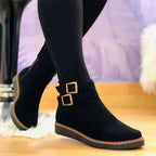 Women’s black ankle boots with side buckle straps and low cushioned sole