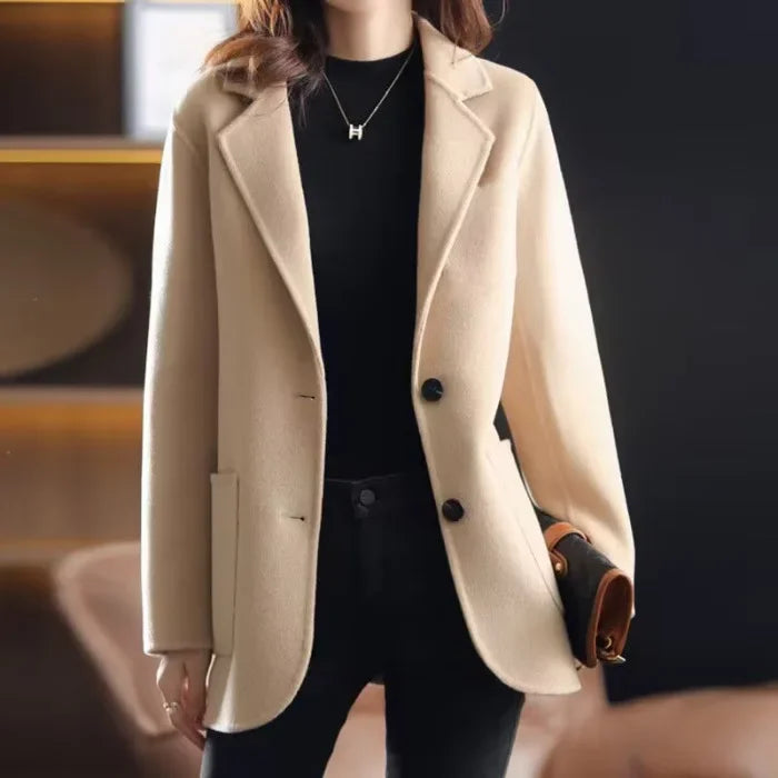 Ivory wool blazer with notched lapels, two-button front, and flap side pocket