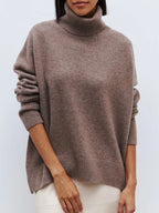 Taupe oversized merino-wool blend turtleneck sweater with ribbed collar and cuffs