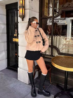 Beige teddy fleece jacket with front toggle closures and long sleeves
