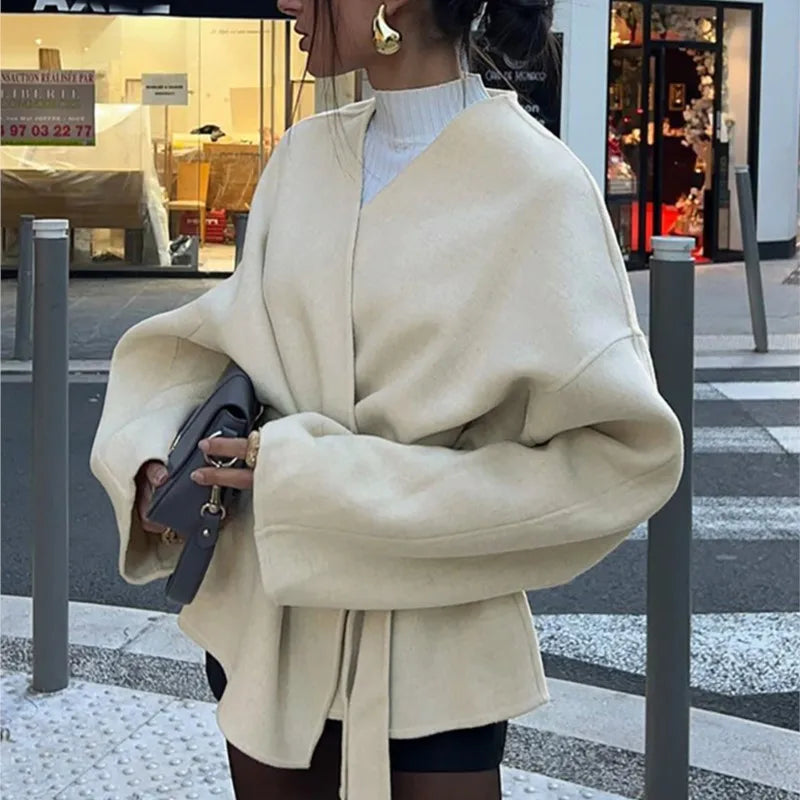 Ivory wrap coat with tie waist, wide sleeves, and open front