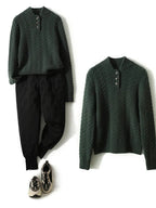Dark green button-up cashmere sweater with cable knit texture and button placket