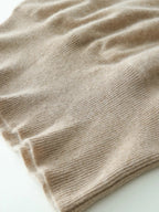 Close-up of beige ribbed knit hem with soft, fuzzy surface finish