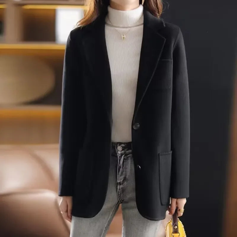 Black wool blazer with notched lapel, single-breasted button front, side pockets