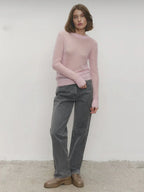 Light pink crewneck knit sweater, long sleeves, ribbed crew neckline and hem
