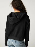 Black waffle zip hoodie with hood, shown from the back and over shoulders.
