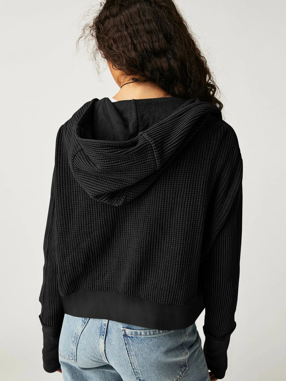 Black waffle zip hoodie with hood, shown from the back and over shoulders.