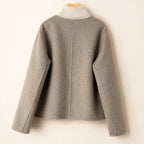Gray button-back jacket with ribbed turtleneck collar.