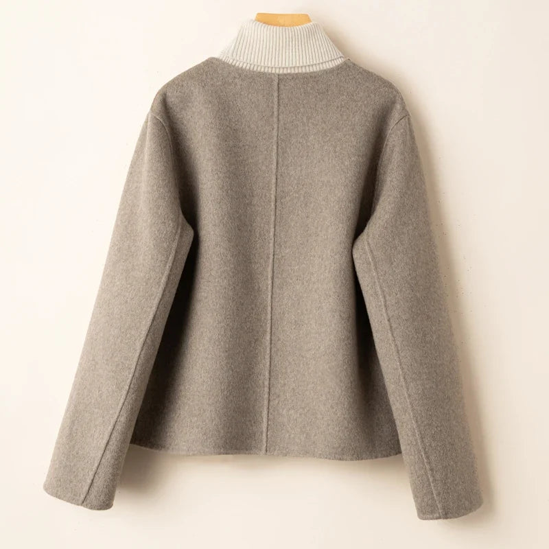 Gray button-back jacket with ribbed turtleneck collar.