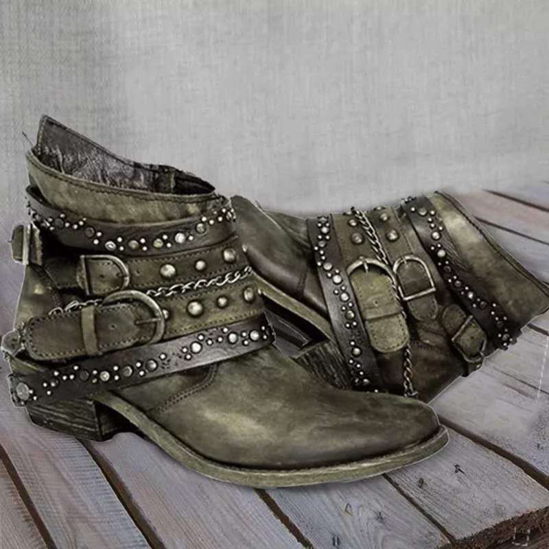 Green vintage ankle boots with studded straps, buckled closures, and chain accent