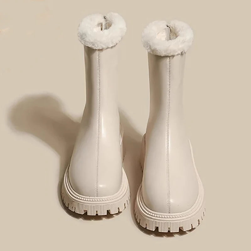 Cream ankle boots with plush fleece collar and textured traction sole pair