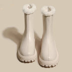 Cream ankle boots with plush fleece collar and textured traction sole pair