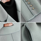 Light blue-gray overcoat with stand collar, decorative buttons, and curved hem