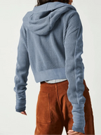 Blue waffle knit zip hoodie with hood and ribbed hem; back view.