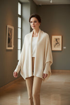 Cream wool shawl with open front drape, knit texture, and hemmed ends