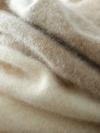 Ivory crossover knit sweater seam and ribbed knit detail