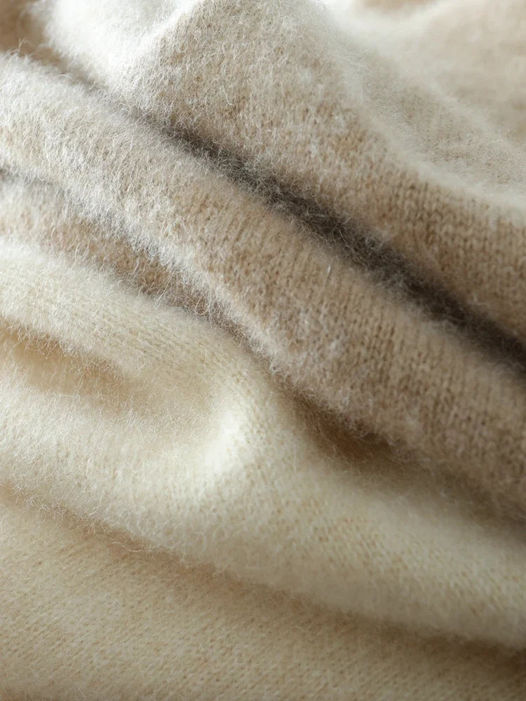Ivory crossover knit sweater seam and ribbed knit detail