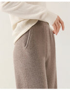 Taupe knit wide-leg pants, ribbed waistband and soft heathered merino texture.