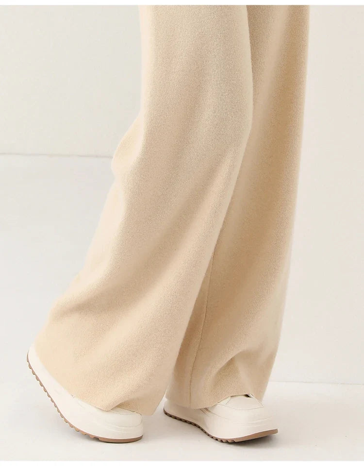 Ivory merino wool wide-leg knit pants, full-length relaxed fit with side seam.