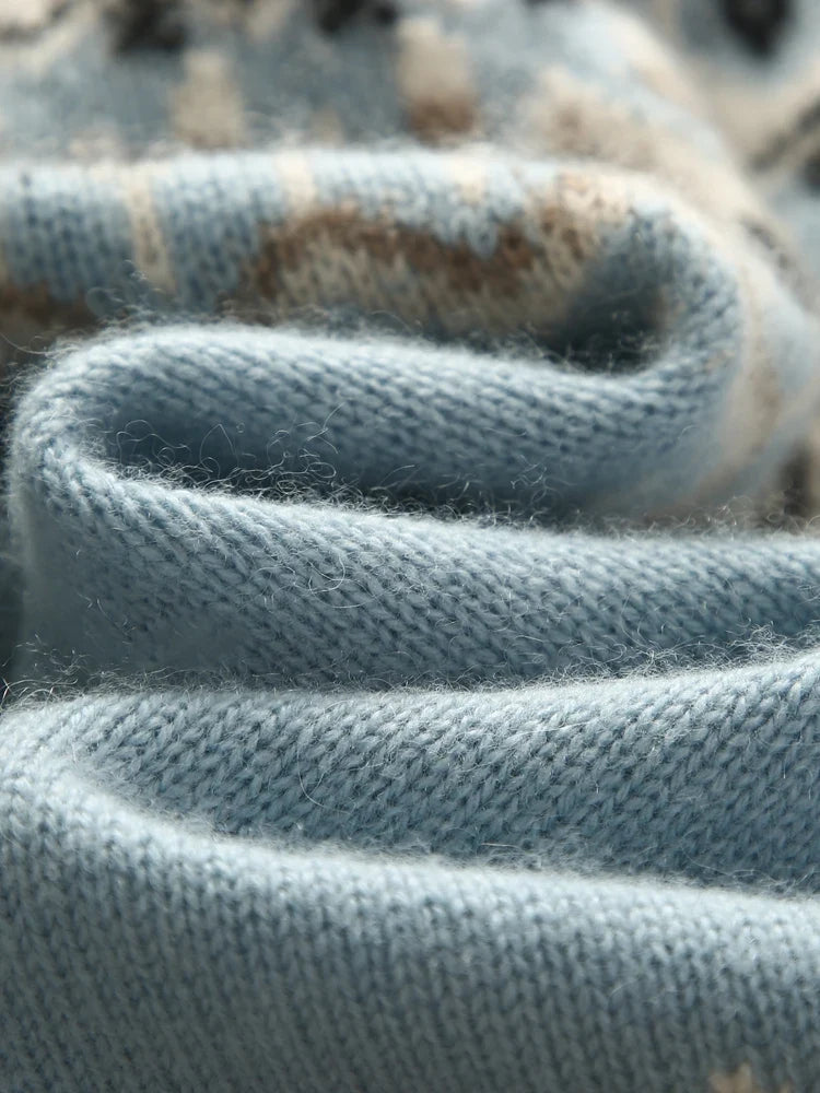 Sky blue knit fabric close-up with ribbed texture and braided fold