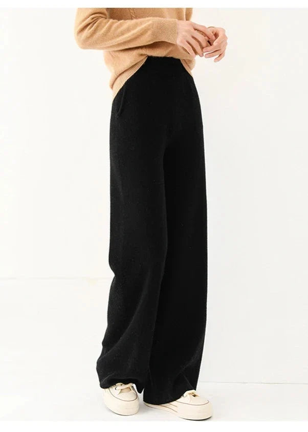 Black wide-leg knit pants with pull-on waistband and relaxed drape, full length.