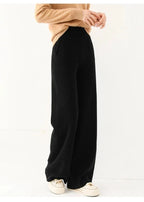 Black wide-leg knit pants with pull-on waistband and relaxed drape, full length.