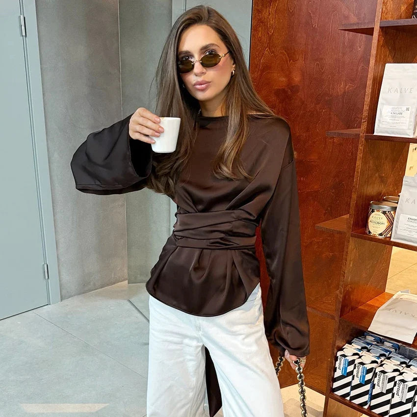 Dark brown satin high-neck blouse with long sleeves and ruched waist detail