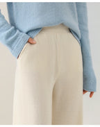 Women’s wide-leg knit pants in cream, waistband and side seam detail close-up