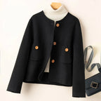 Black button-front jacket with ribbed high collar and two patch pockets.