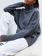 Dark blue oversized turtleneck sweater, knit texture with ribbed collar and cuffs