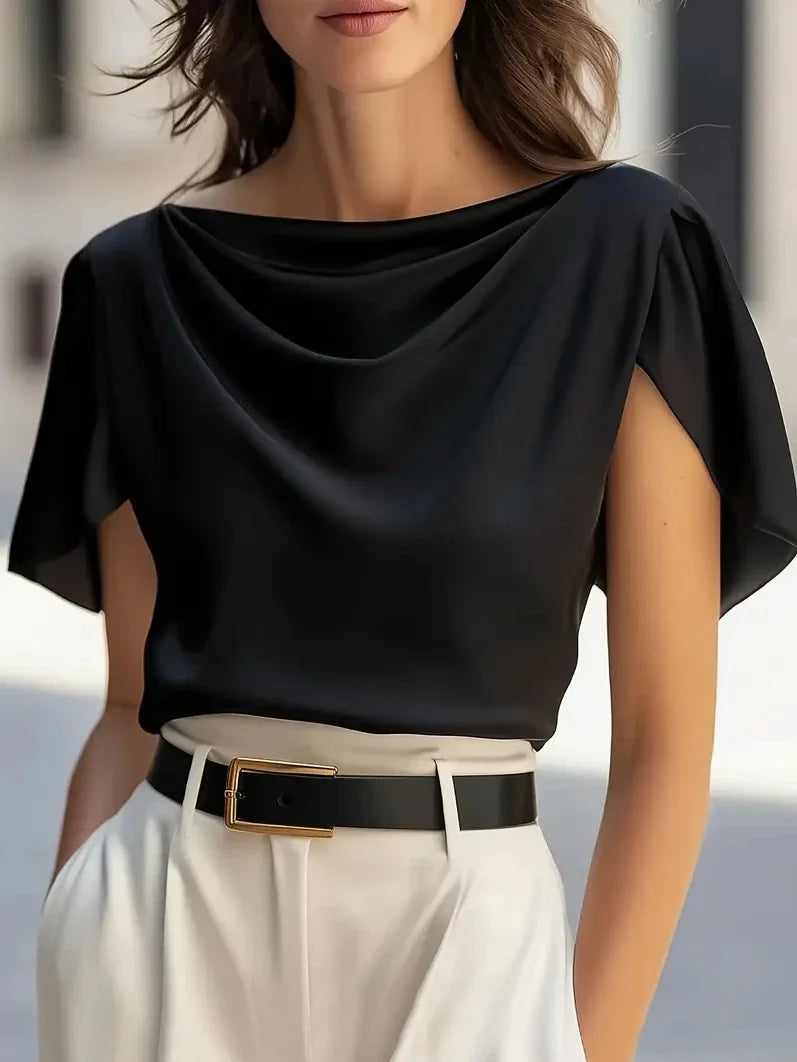 Black draped cowl-neck blouse with short sleeves and layered neckline drape.
