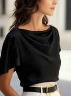 Black draped cowl-neck blouse with short sleeves and soft neckline drape.