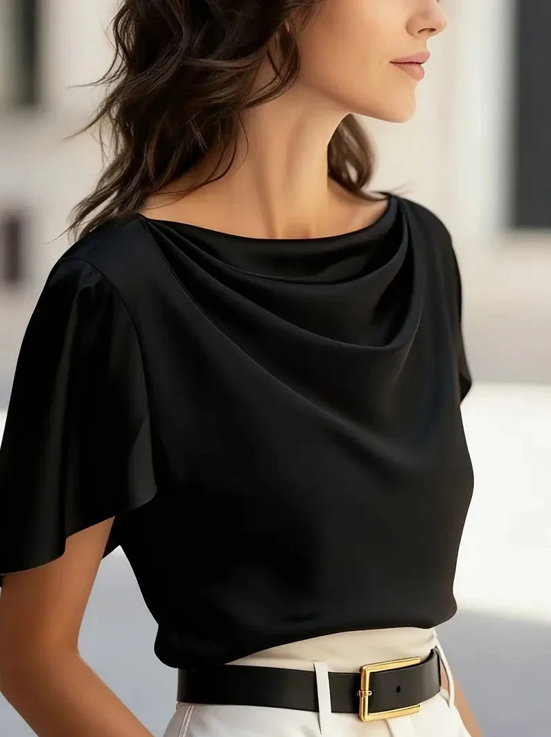Black draped cowl-neck blouse with short sleeves and soft neckline drape.