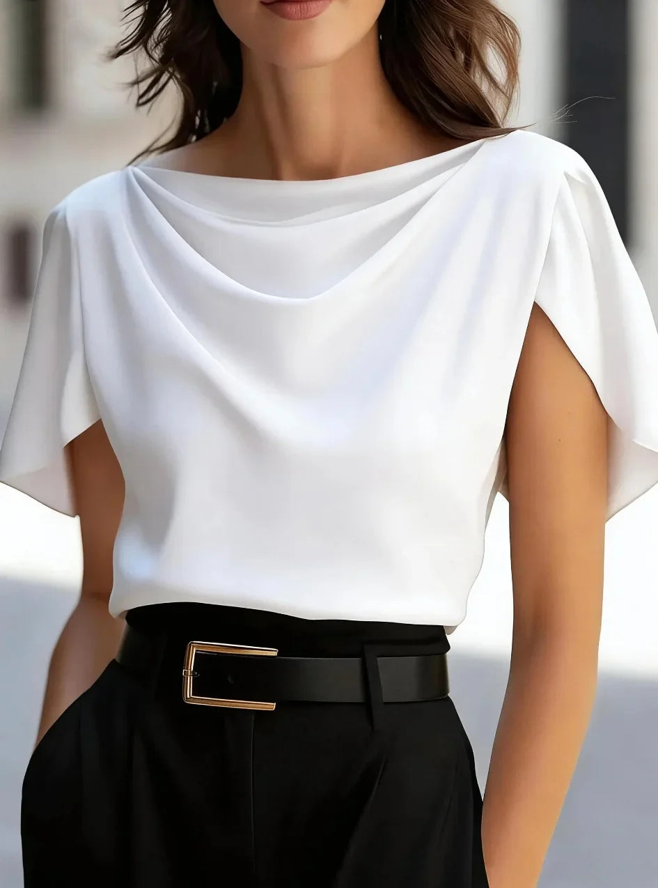 White draped cowl-neck blouse with short sleeves and layered neckline drape.